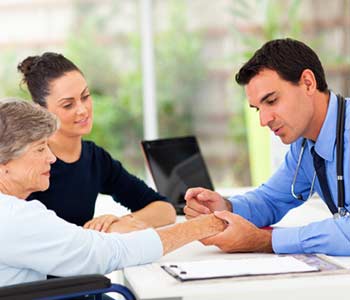 Dermatologist inspecting senior patient skin in office