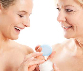 Beauty and skin care - mother and daughter with cream