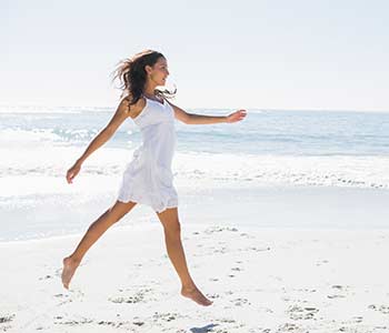 Young lady walking on the beach